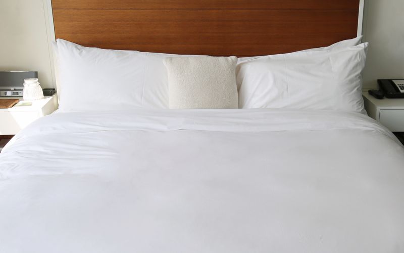 Bed with comforter in hotel room