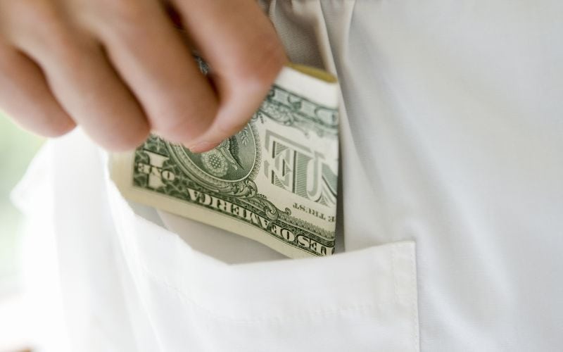 Hotel housekeeper receiving cash tip