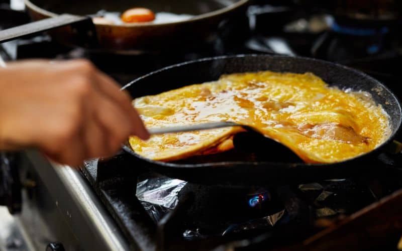 Chef making omelet in hotel kitchen