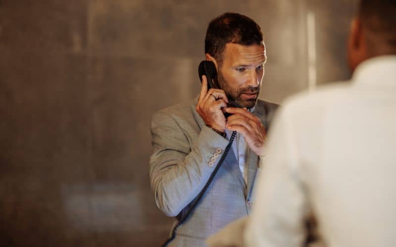 Hotel receptionist receiving phone call