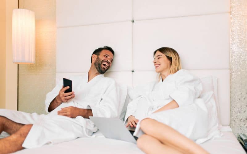 Young couple talking and relaxing at hotel room