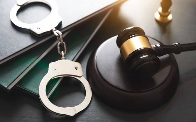 Gravel, handcuff and document on table