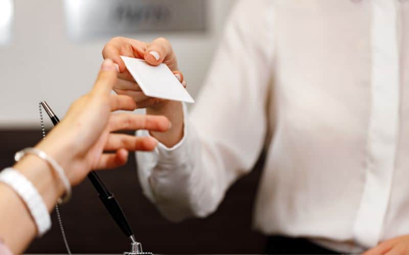 Woman receiving hotel room key card