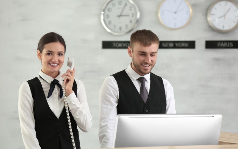 Happy hotel receptionists at work