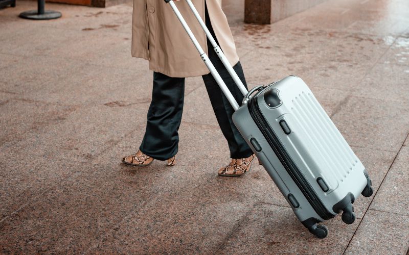 A woman holding her luggage