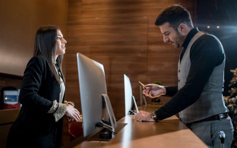 Businessman checking in at hotel with credit card