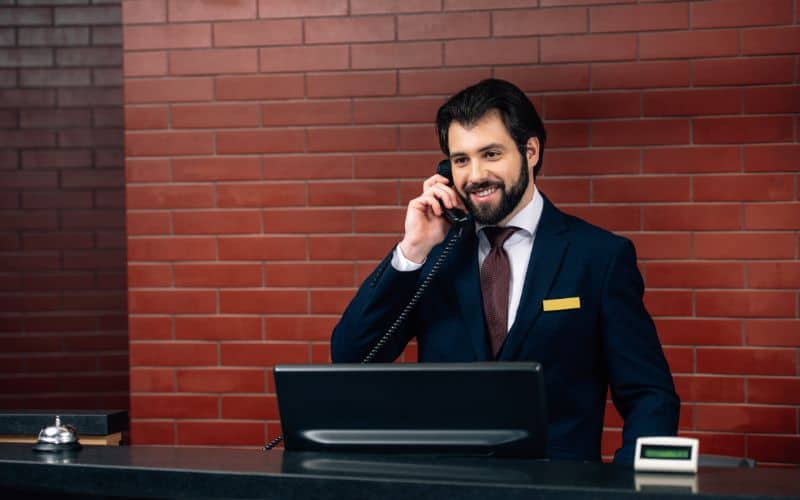 Hotel receptionist receiving phone call