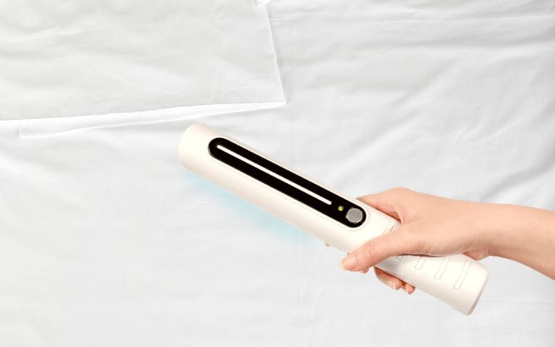 Using portable UV-C light to disinfect bed sheets