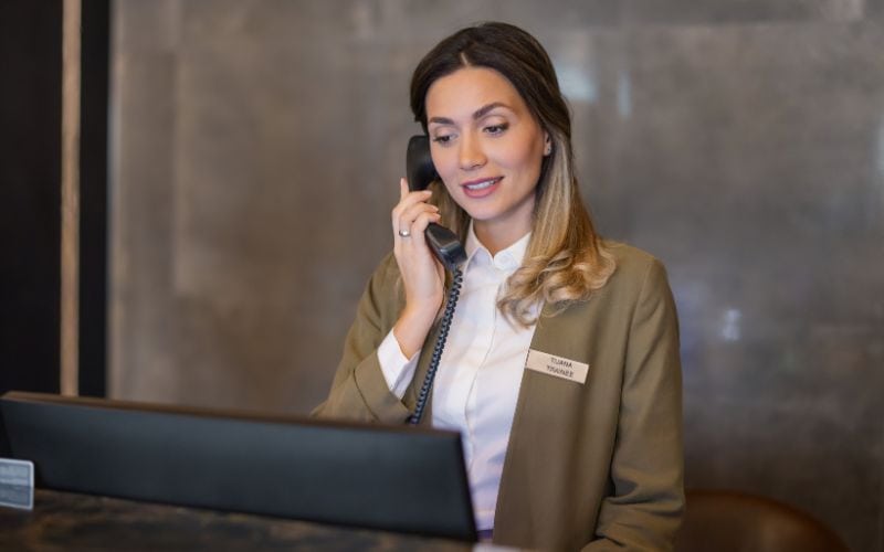 Hotel receptionist talking on the phone
