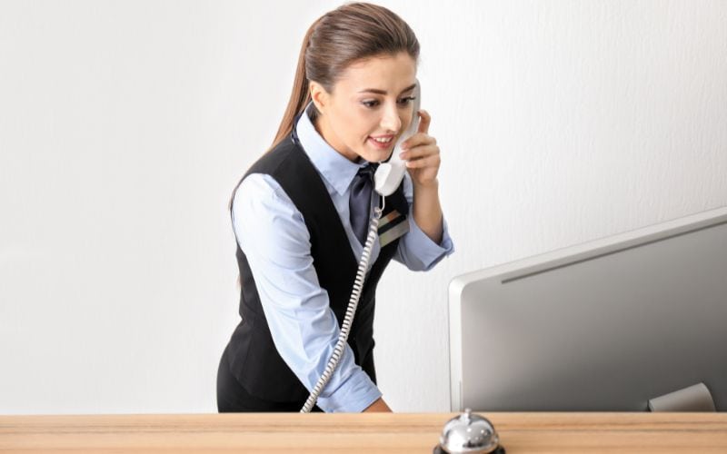 Female hotel receptionist talking on phone