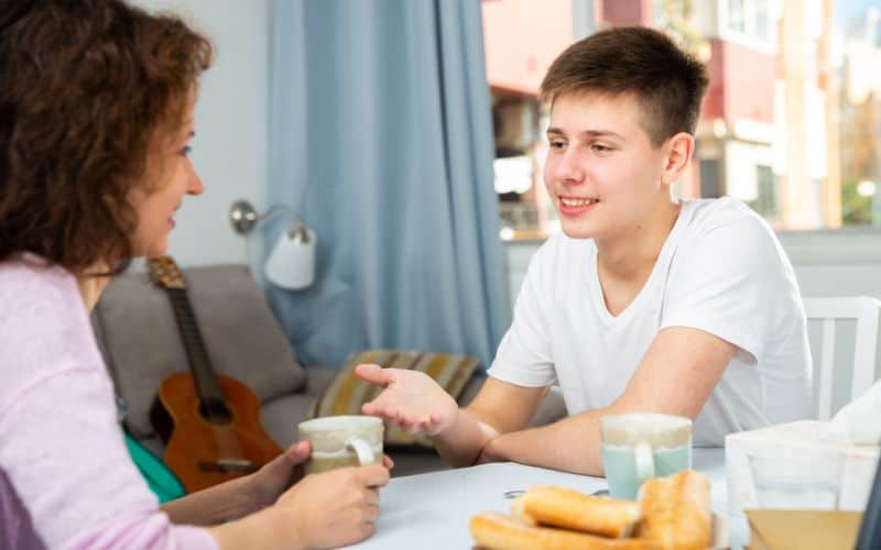 A teenager talking to his mom