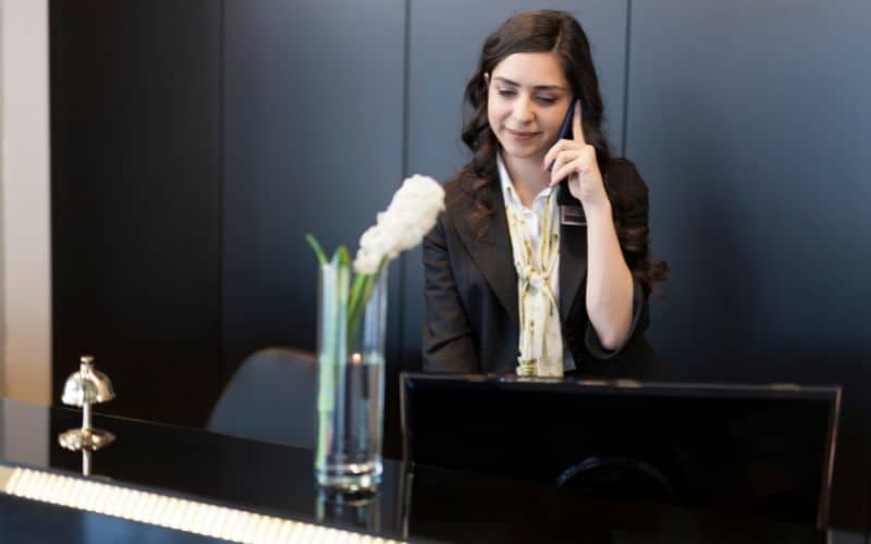 Front desk of hotel talking on phone