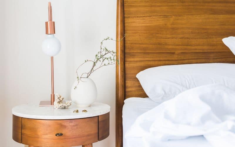 Wooden hotel bed and nightstand