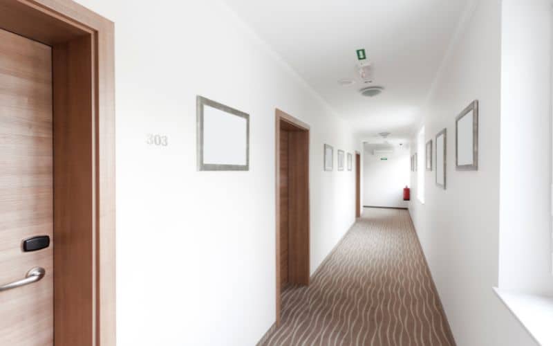 A hotel hallway with many doors