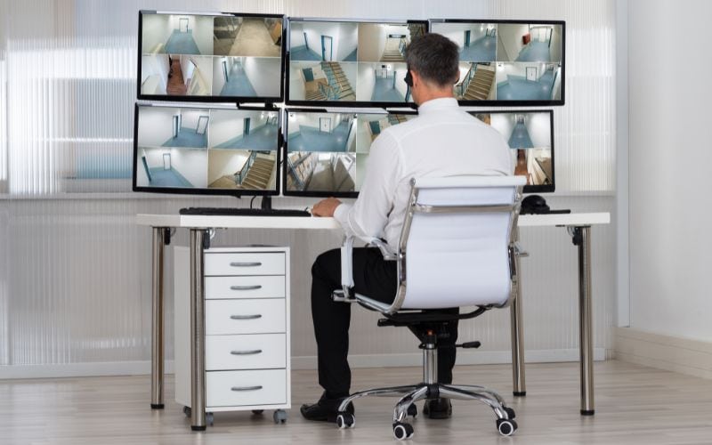 Security system operator monitoring CCTV footage