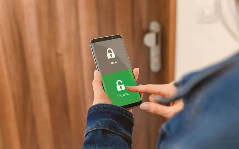 Woman hand unlock hotel door key using phone
