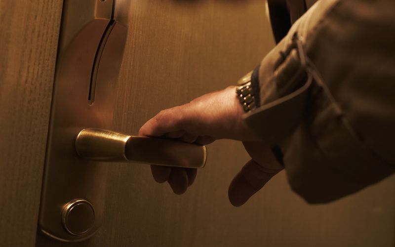 Man opening hotel room door