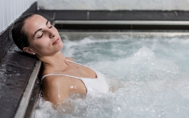 Female relaxing in jacuzzi tub