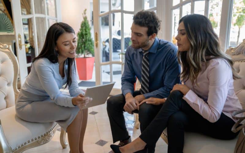 Couple talking to hotel manager